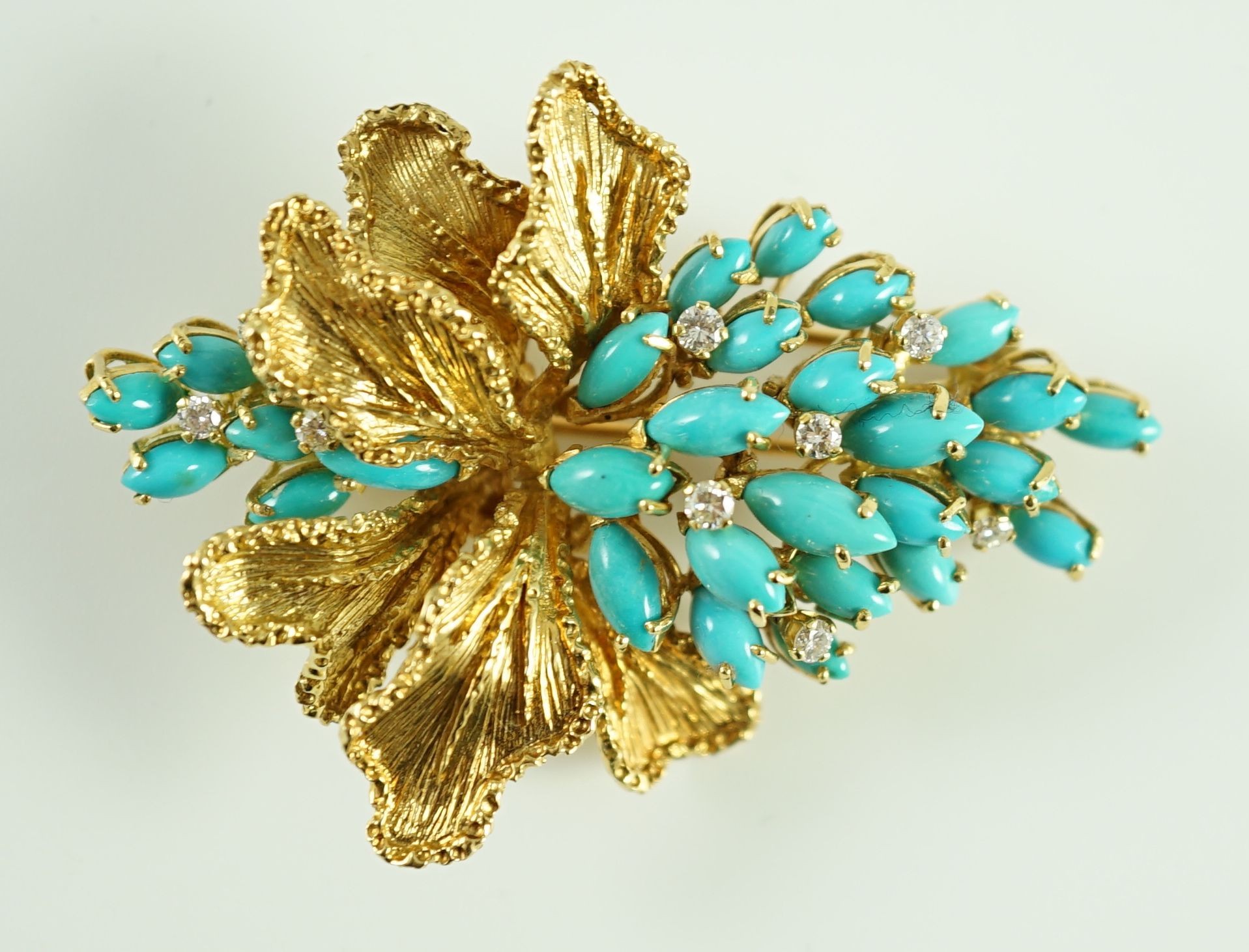 A 1970's textured 18ct gold, turquoise and diamond set cluster clip brooch